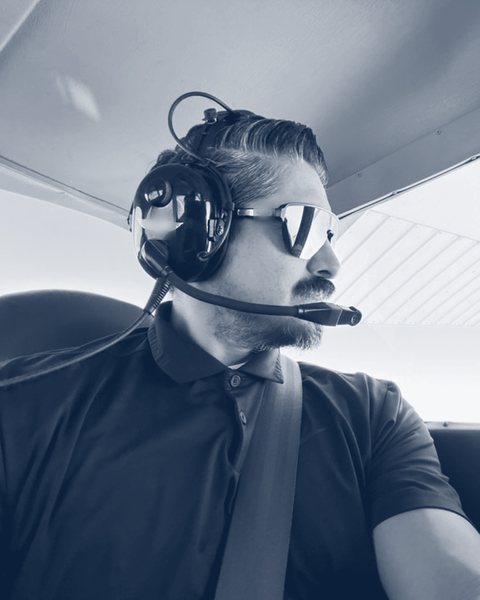 Javier Rodriguez, founder of CyberWing, in the cockpit wearing a headset